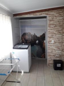 a small refrigerator in a room with a window at Casa do Henrique 1 in Sorocaba +36 photos