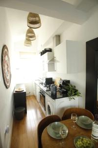 a kitchen with a table and a kitchen with a stove at Very Nice Flat close to Camden Station in London