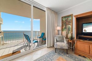 a living room with a view of the ocean at Beach Club Avalon 1204 in Gulf Highlands
