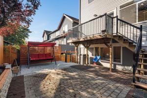 a patio with a red bench and a deck at Phinney Guest House BY Betterstay in Seattle