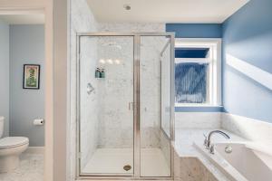 a bathroom with a shower and a toilet at Phinney Guest House BY Betterstay in Seattle
