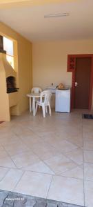een woonkamer met een tafel en stoelen en een keuken bij Duplex na Praia dos Ingleses in Florianópolis
