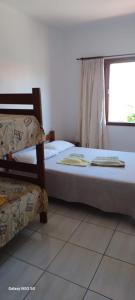 Een bed of bedden in een kamer bij Duplex na Praia dos Ingleses