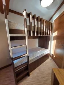 a bunk bed with a ladder in a room at Apartment B513 in Jahorina
