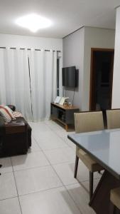 a living room with a couch and a tv at APARTAMENTO JOÃO PESSOA BESSA in João Pessoa