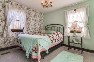 a bedroom with a bed and a chandelier at Serene Tell City Retreat Near Hiking and Skiing! in Tell City