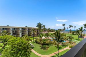an aerial view of a resort with a pool and palm trees at Maui Sunset A513 BY Betterstay in Kihei