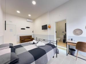 a bedroom with a black and white bed and a desk at Real poggio in Naples