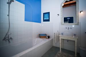 a white bathroom with a tub and a sink at Wijnstaete in Lemelerveld +46 photos