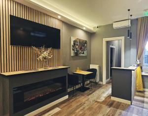 a living room with a fireplace and a flat screen tv at B&B President in Zagreb