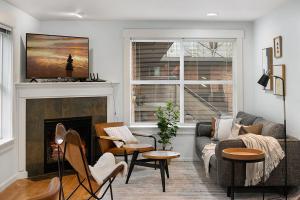 a living room with a couch and a fireplace at Aurora Abode BY Betterstay in Seattle