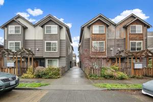 a row of houses on a street with a driveway at Aurora Abode BY Betterstay in Seattle