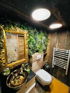 a bathroom with a plant wall with a toilet at Tiny House Všemily in Jetřichovice +34 photos