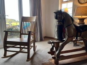 a statue of a horse standing next to a rocking chair at Brownhills in Eaton