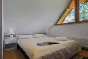 1 dormitorio con 1 cama con sombrero en Pensjonat Arnika, en Zakopane