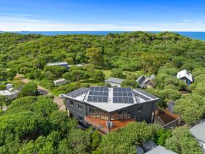 an aerial view of a house with solar panels on the roof at Beach Escape Penthouse 2 Bdr Apartment in Sandy Point