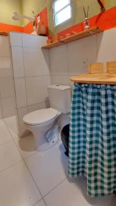 a bathroom with a toilet in a room at Casa de Mar Sagi in Baía Formosa
