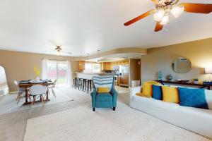 a living room with a couch and a dining room at Time for Tempe in Tempe