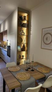 a dining room with a table and a kitchen at Gjirokastra Design Apartments in Gjirokastër