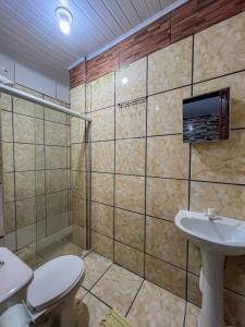 a bathroom with a toilet and a sink at pousada Vitoria in Morro de São Paulo