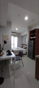 sala de estar con cama, mesa y escritorio en HOLIDAY Staycation, en Pekayon Dua