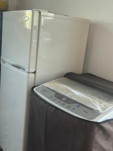a refrigerator with a plastic cover on top of it at Hospedaje de la Abuela in Salinas