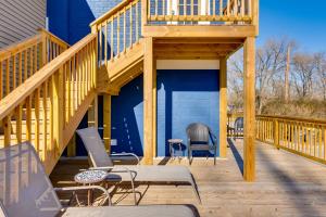 a large wooden deck with chairs and a balcony at Walkable Downingtown Studio with Spacious Deck in Downingtown