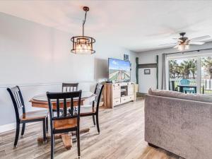 a living room with a table and a couch at Bayfront Kontiki 704 in Rockport