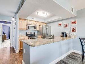 a kitchen with a sink and a counter top at Bayfront Kontiki 704 in Rockport