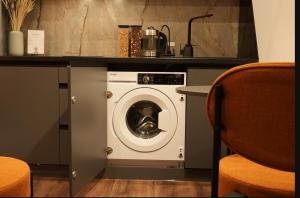 a washing machine in a kitchen with a counter at Luxury apartment with jacuzzi Pechersk Plaza in Kyiv