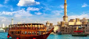 a boat in the water in front of a city at Modern Hostel Dubai in Dubai