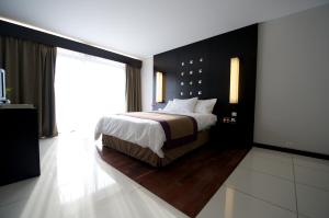 Voodi või voodid majutusasutuse Hotel Tahiti Nui toas