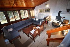 a living room with a couch and a stove at Pink House Lipno in Lipno nad Vltavou