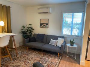 a living room with a couch and a window at Newly renovated, modern and cosy one bedroom condo with full kitchen and lounge in Redding