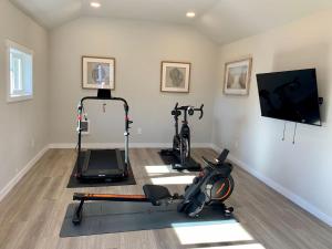 a gym with three exercise bikes in a room at The I5 Suite BY Betterstay in Seattle
