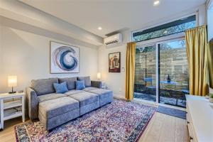 a living room with a couch and a large window at Wallingford Comfort BY Betterstay in Seattle