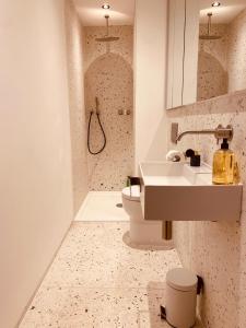 a bathroom with a sink and a toilet at Spacious 3 Bed City Apartment with Terrace in London
