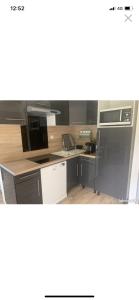 a kitchen with black appliances and wooden counters at Les Orres 1650 Résidence l'Oustal in Les Orres