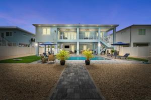 a large house with a pool in front of it at Mermaid's Paradise ~ Pool ~ Dock ~ Games ~ Views in Marathon +86 photos