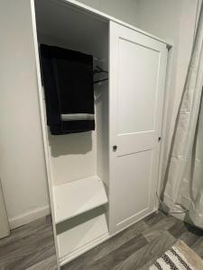 a white closet with a tv and a white door at SUITE DREAMs CARROLL 10 in Paterson