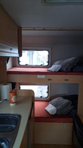 a small room with two bunk beds and a counter at Autocarabana Ford trigano in Arrecife