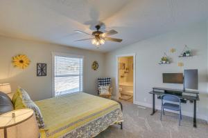 a bedroom with a bed with a ceiling fan and a desk at Modern Bloomington Home about 10 Mi to Bear Lake! in Bloomington