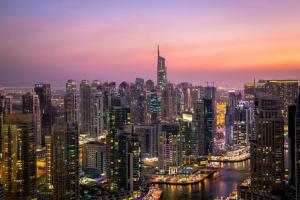 a view of a city skyline at night at Star Capsule Hostel Near Burjuman Metro Station in Dubai