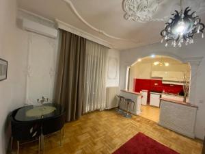 a large living room with a chandelier and a table at Apartment with Balcony and AC next to Danube in Budapest