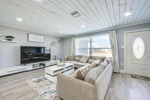 a living room with a couch and a tv at Florida Gulf Coast Getaway Pool and Screened Lanai! in Rotonda West