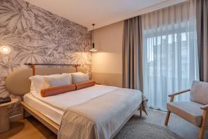 Postel nebo postele na pokoji v ubytování Oli Hotel and Suites