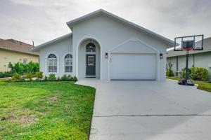 a white house with a basketball hoop at Central Naples Home with Private Pool, Spa and Lanai! in Naples