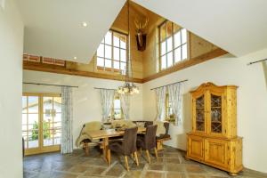 a dining room with a table and chairs at Chalet unter weiß-blauem Himmel in Reit im Winkl