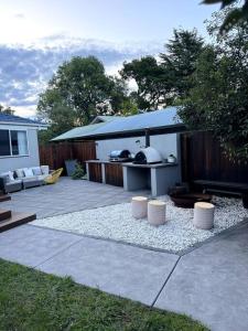 a backyard with a patio with a table and a grill at Inner City Boutique Home. Pet and Family Friendly! in Canberra