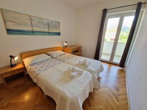 Postel nebo postele na pokoji v ubytování APARTMENTS JOSIPA